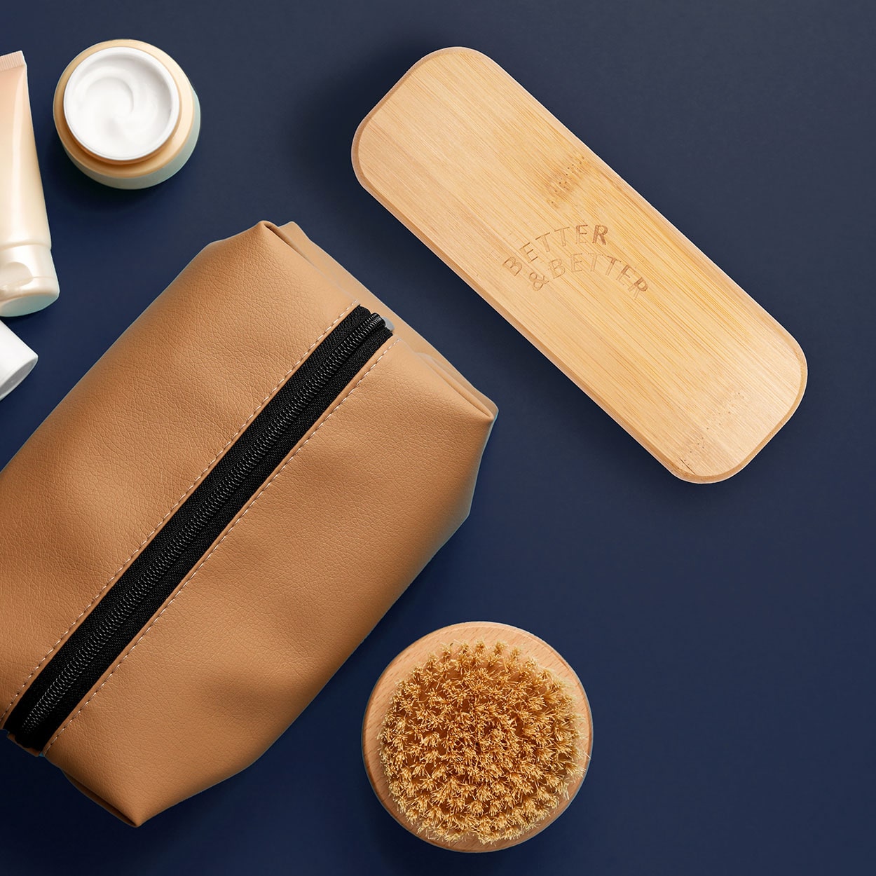 Bamboo Travel Case for Better & Better Bamboo Sonic Toothbrush. Zero plastic, made of natural bamboo. Case is placed next to toiletry bag and toiletry items.