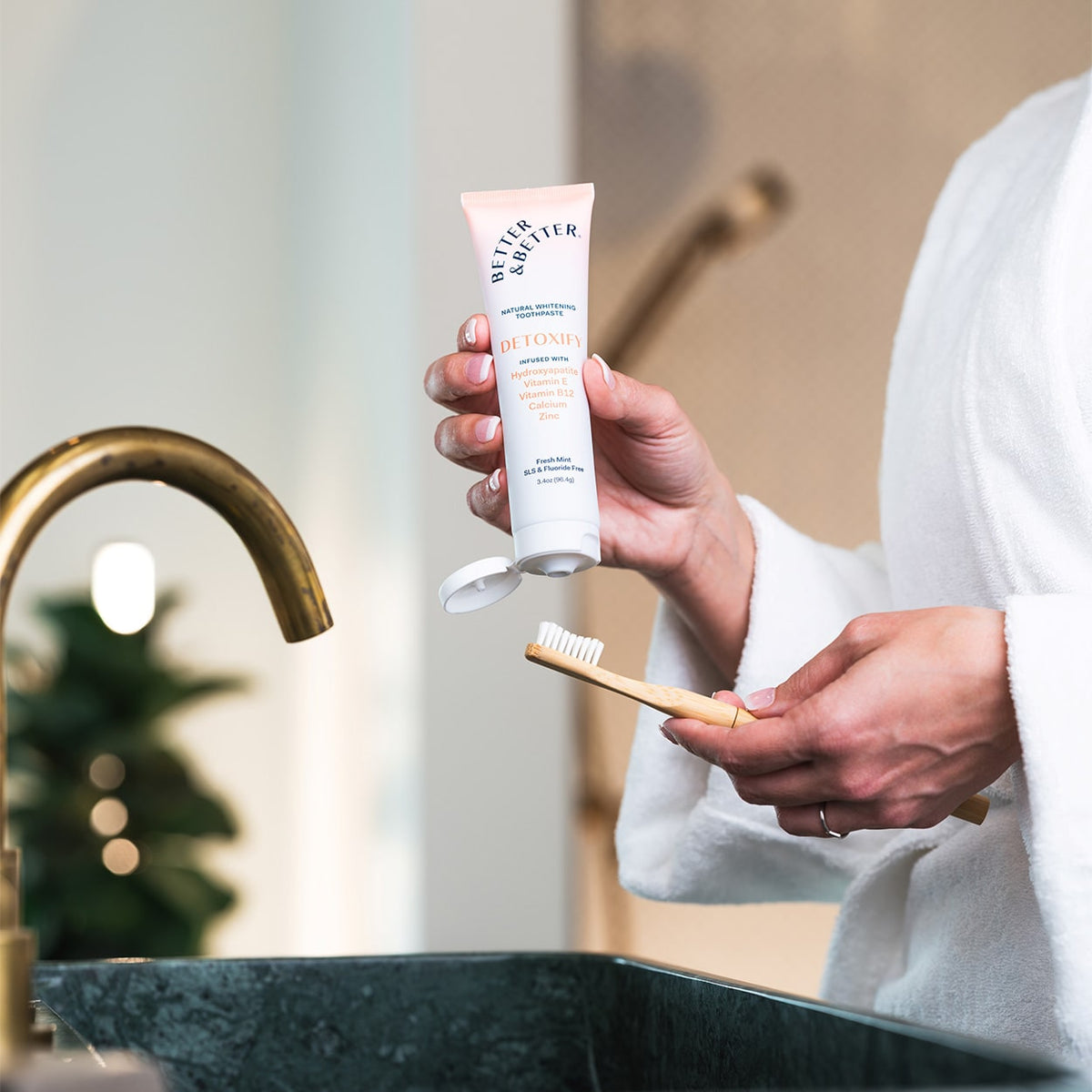 Detoxify Zinc Toothpaste tube beside a green sink